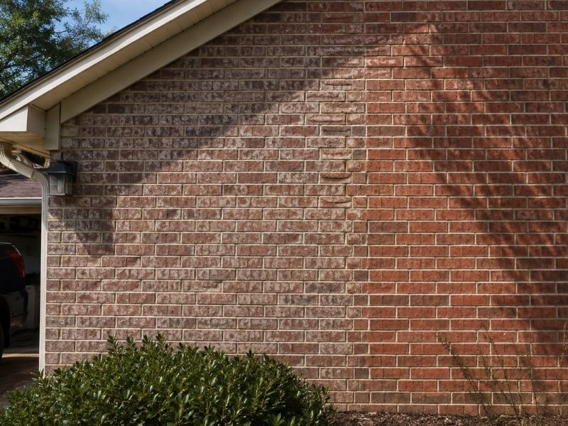 Brick exterior wall showing uneven color changes after years of sun exposure at a home in McKinney, TX.