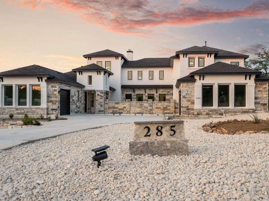 Luxury home with extensive stone masonry and varied exterior geometry
